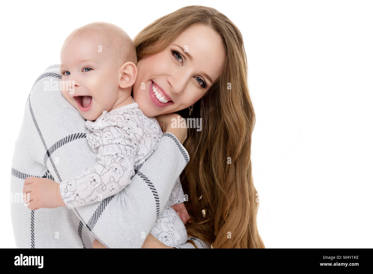 Happy mother hugging her adorable baby son. Happy family. Mother and newborn child portrait isolated on white background. Stock Photo