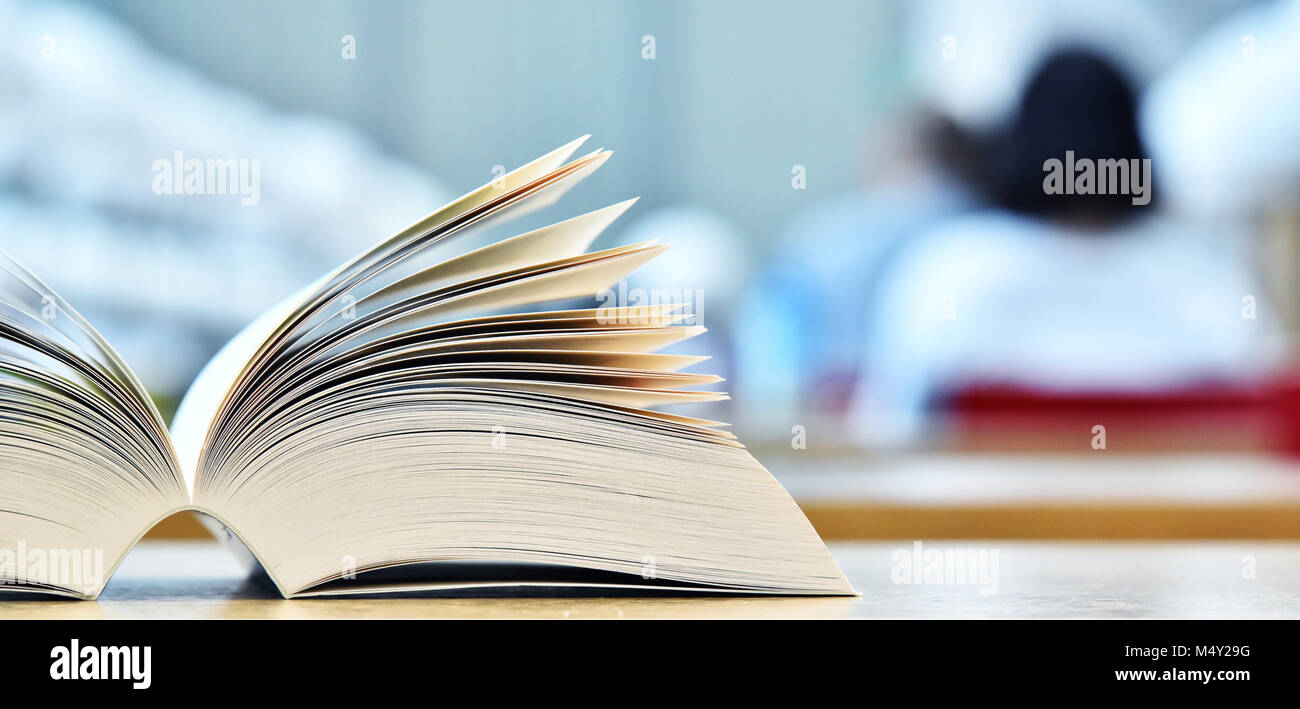 Books lying on the table in the public library. Stock Photo