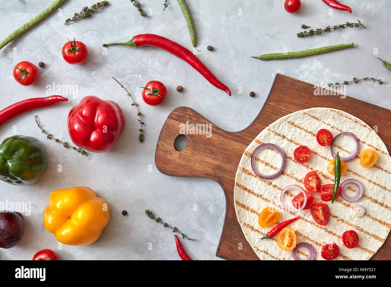 Fresh vegetables and tortilla on a wooden board Stock Photo