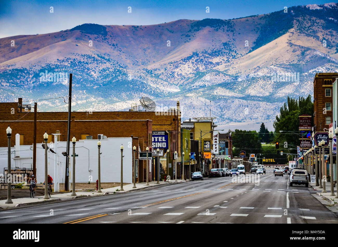 Route 50, the main street in western town of Ely, Nevada is seen against backdrop of mountain range.  Ely was founded as a stagecoach station along th Stock Photo