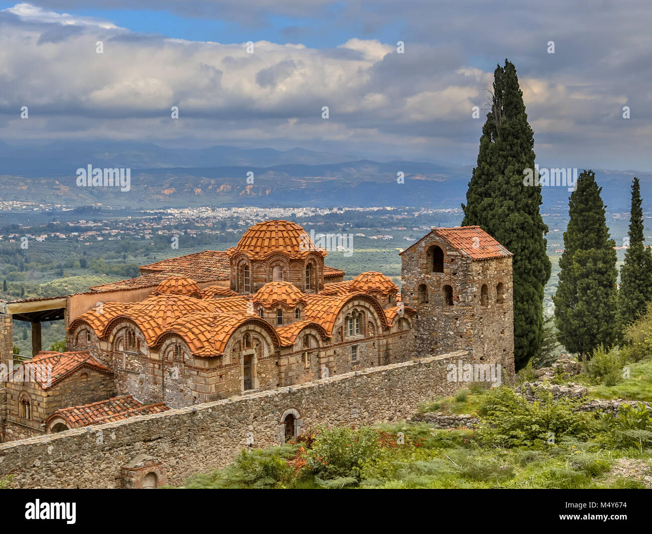Monastery buildings in the medieval Byzantine ghost town-castle of Mystras, with city of Sparta in background Peloponnese, Greece Stock Photo