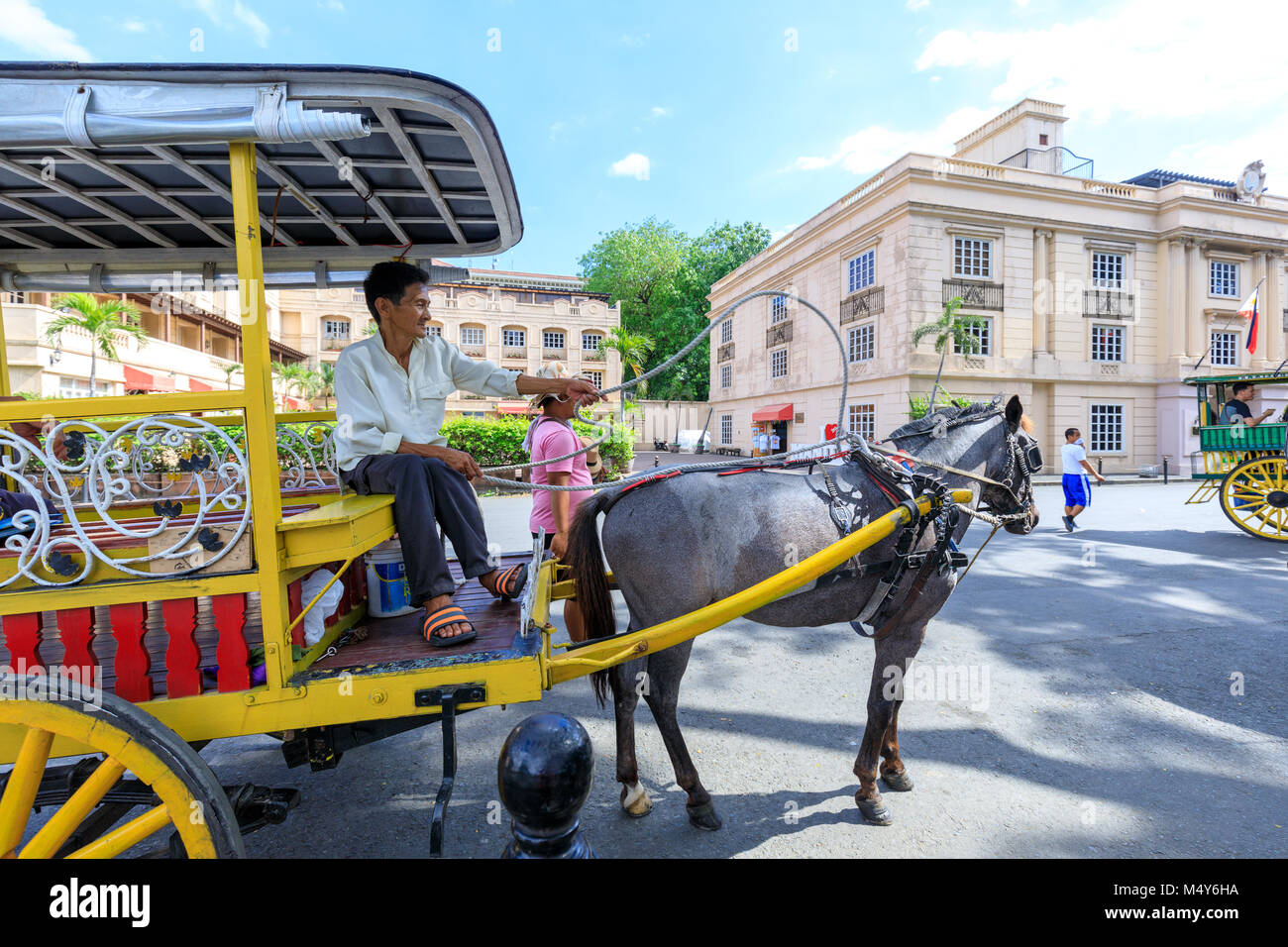 Manila, Philippines - Feb 17, 2018 : Horse with carriage waiting for tourists in Intramuros district Stock Photo