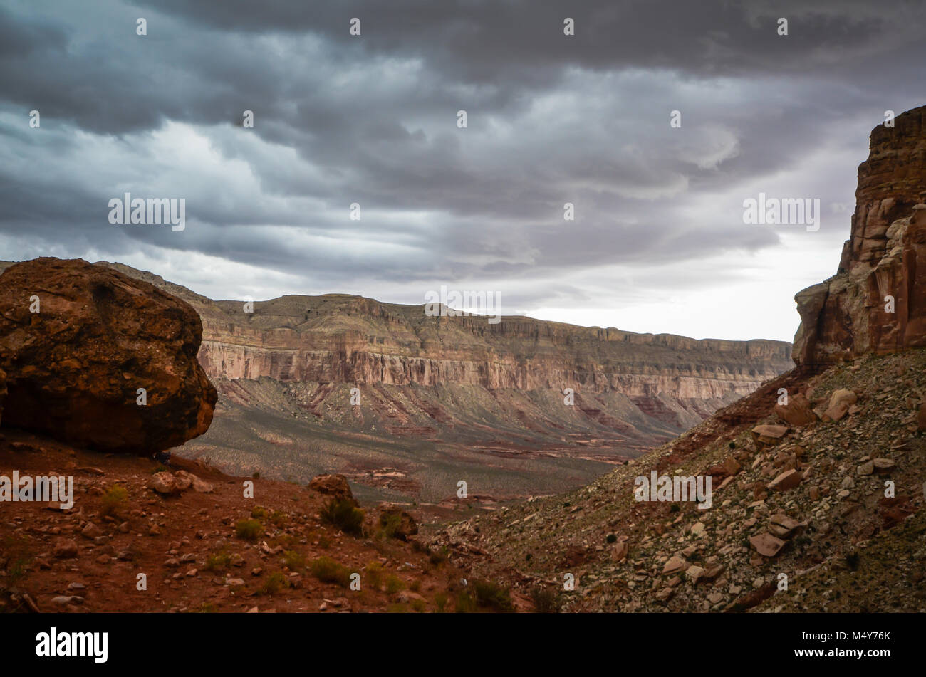 Dark gray storm clouds and red rock canyons on a rainy day on the Hualapai Tribal lands in Arizona. Stock Photo