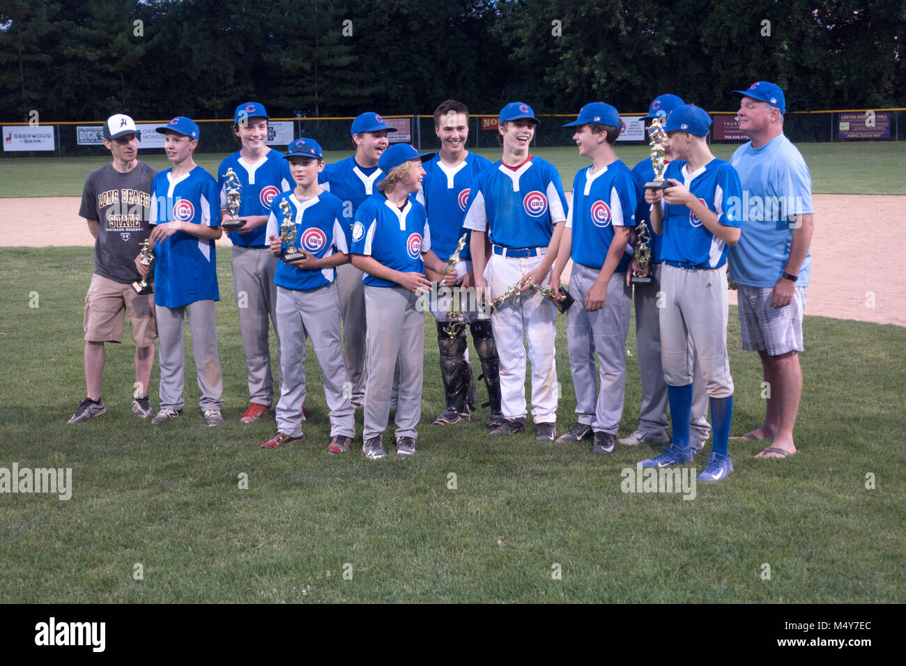 Championship high school baseball team hold their trophies presented at