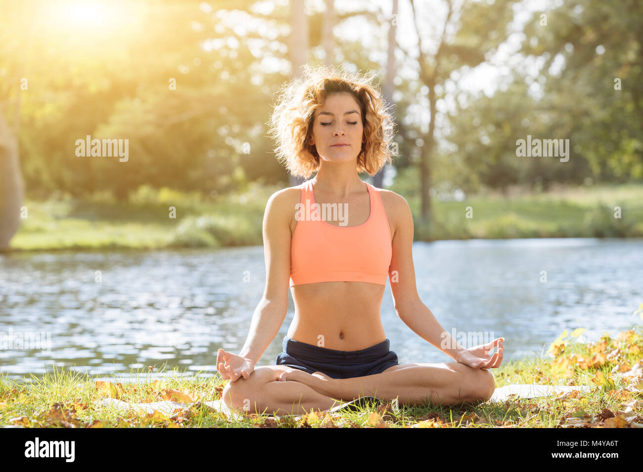 Young woman practicing yoga in nature. Stock Photo