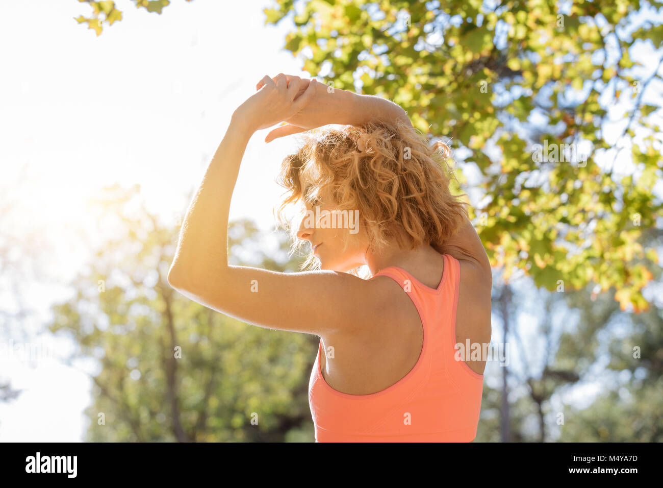 young fitness woman runner stretching arm before run Stock Photo