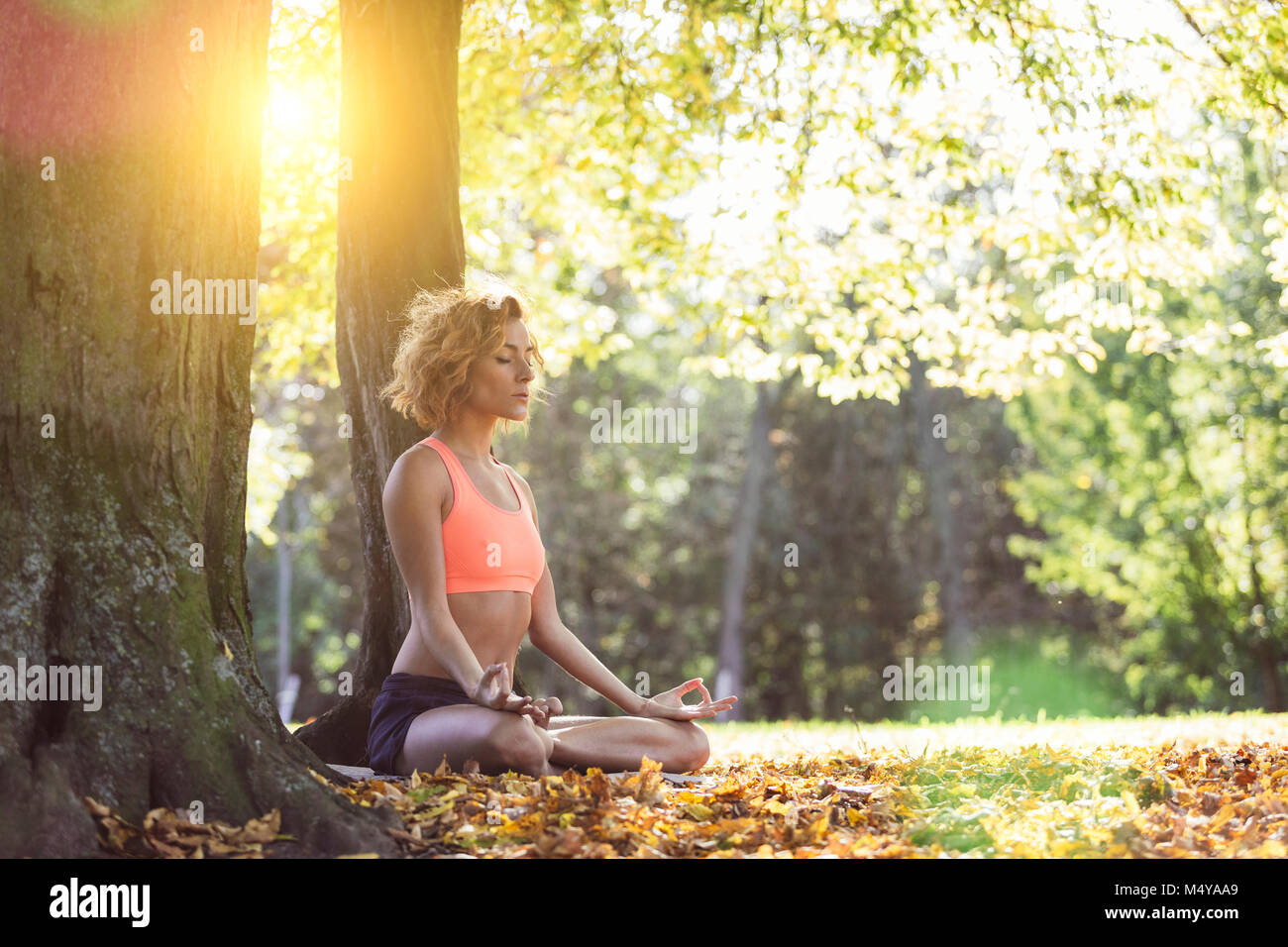 Young woman practicing yoga in nature. Stock Photo