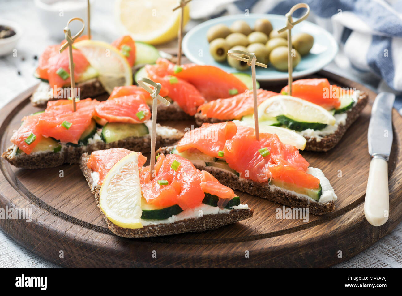 Canape sandwiches with salmon, cucumber and cream cheese. Closeup view