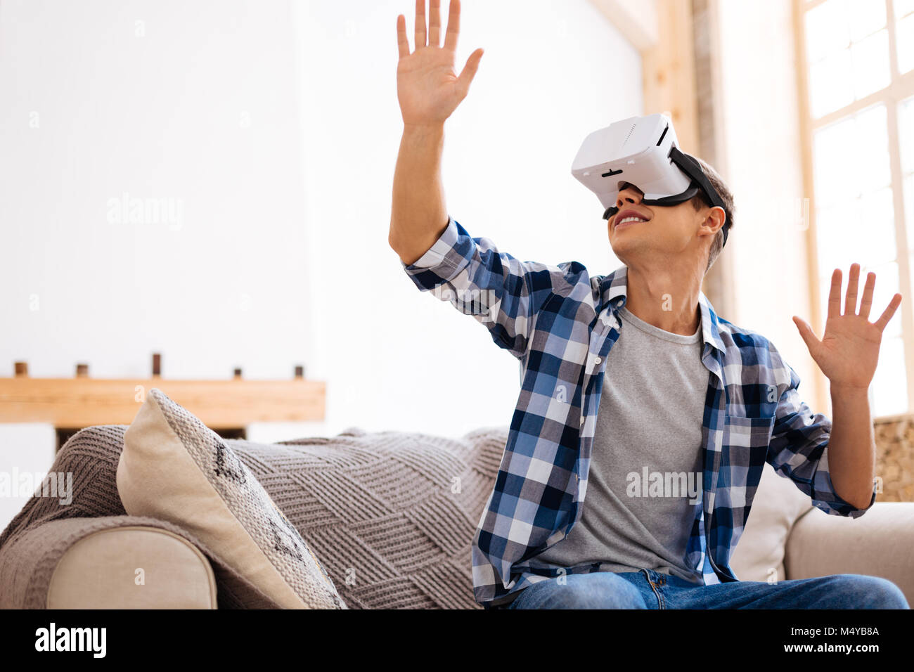 Alert adolescent wearing a VR headset Stock Photo