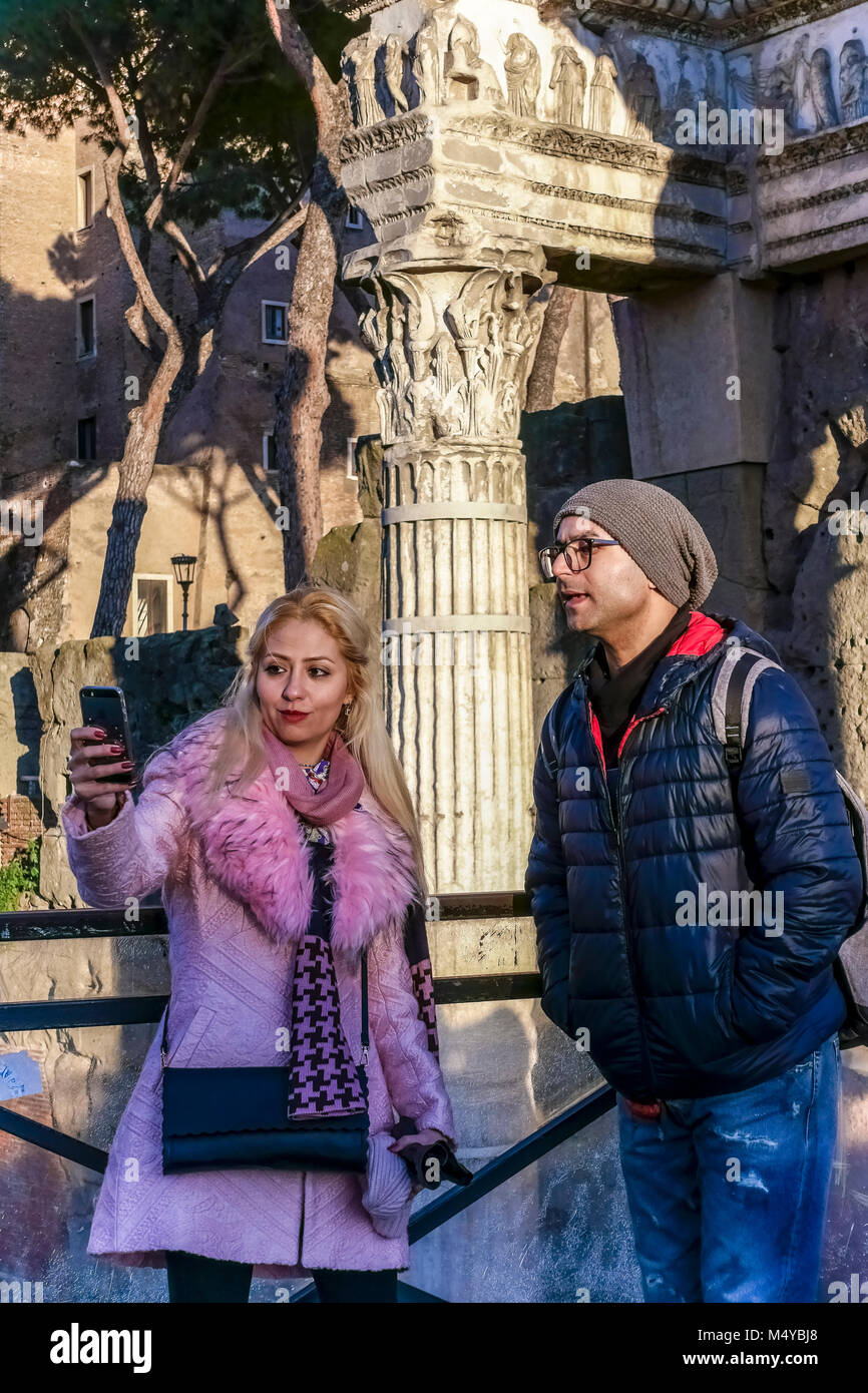 Young caucasian couple taking selfie at the remains of Imperial Roman forum, Trajan's Market, Trajan’s forum. Rome, Latium, Italy, Europe. Close up. Stock Photo
