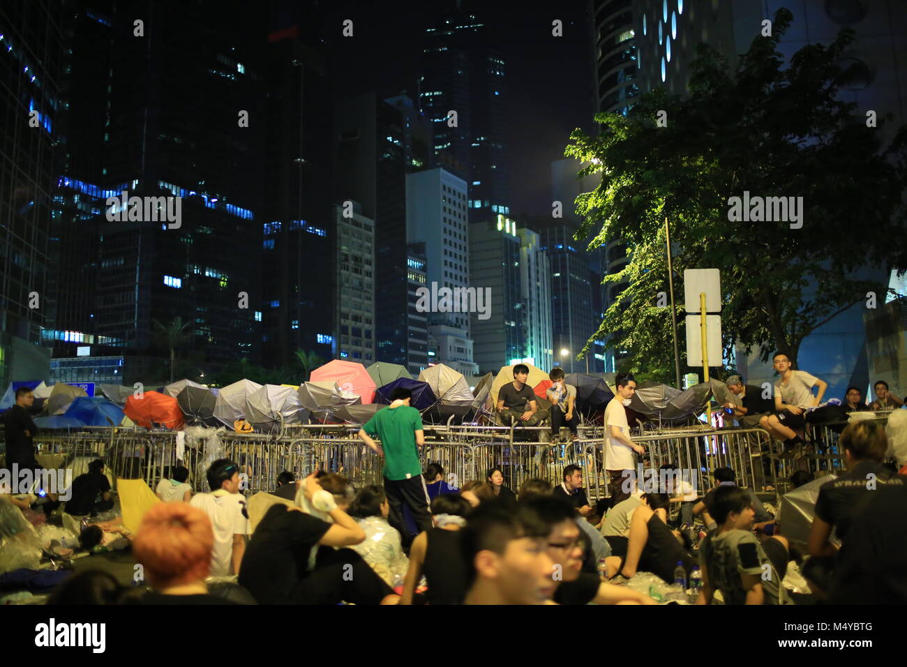 HONG KONG, SEPT.30: protesters occupy the street near government headquarter in Admiralty on 30 September 2014. after riot police fire tear shell to the peaceful protesters, people join the protest Stock Photo
