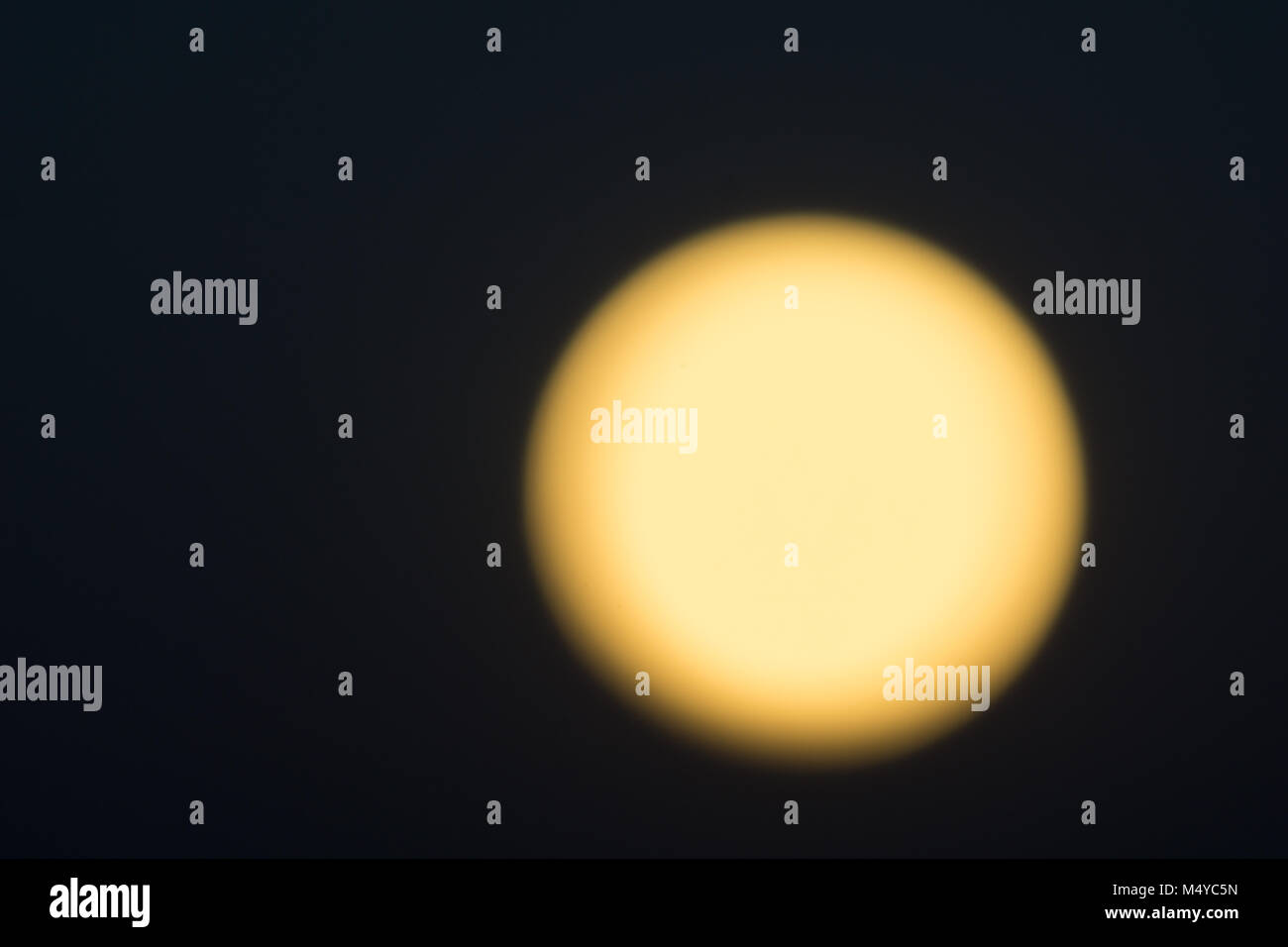 Golden glow of full moon against black night sky Stock Photo - Alamy