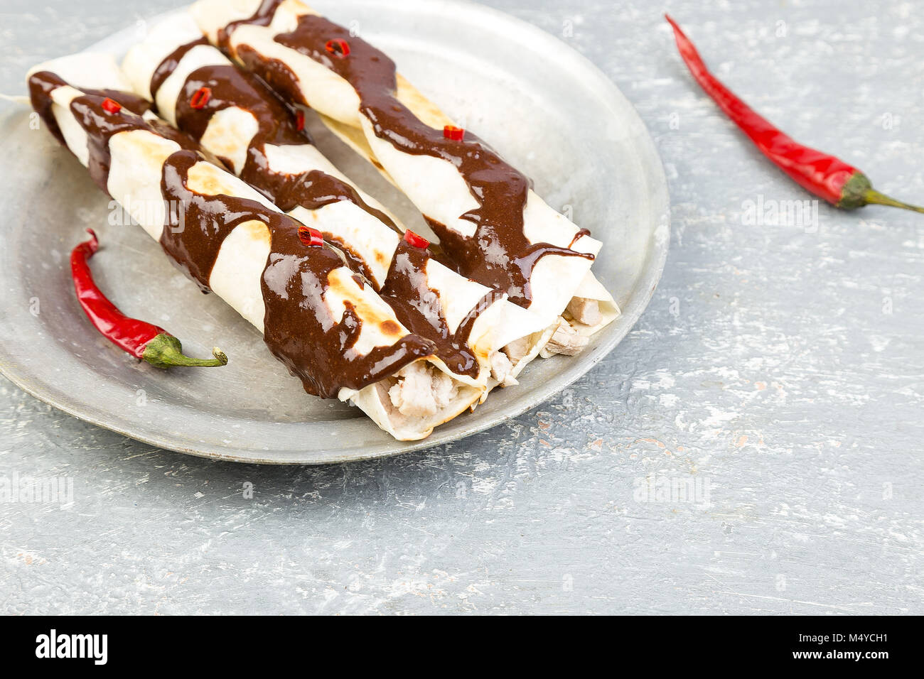 Mexican chicken enchiladas with chili chocolate salsa mole poblano
