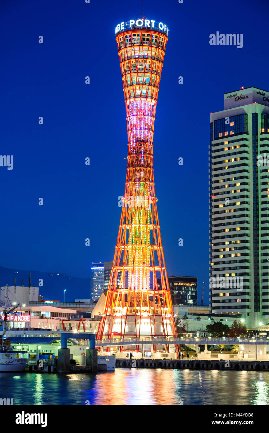 Japan, Kobe. Night time view of the illuminated orange Kobe Port Tower