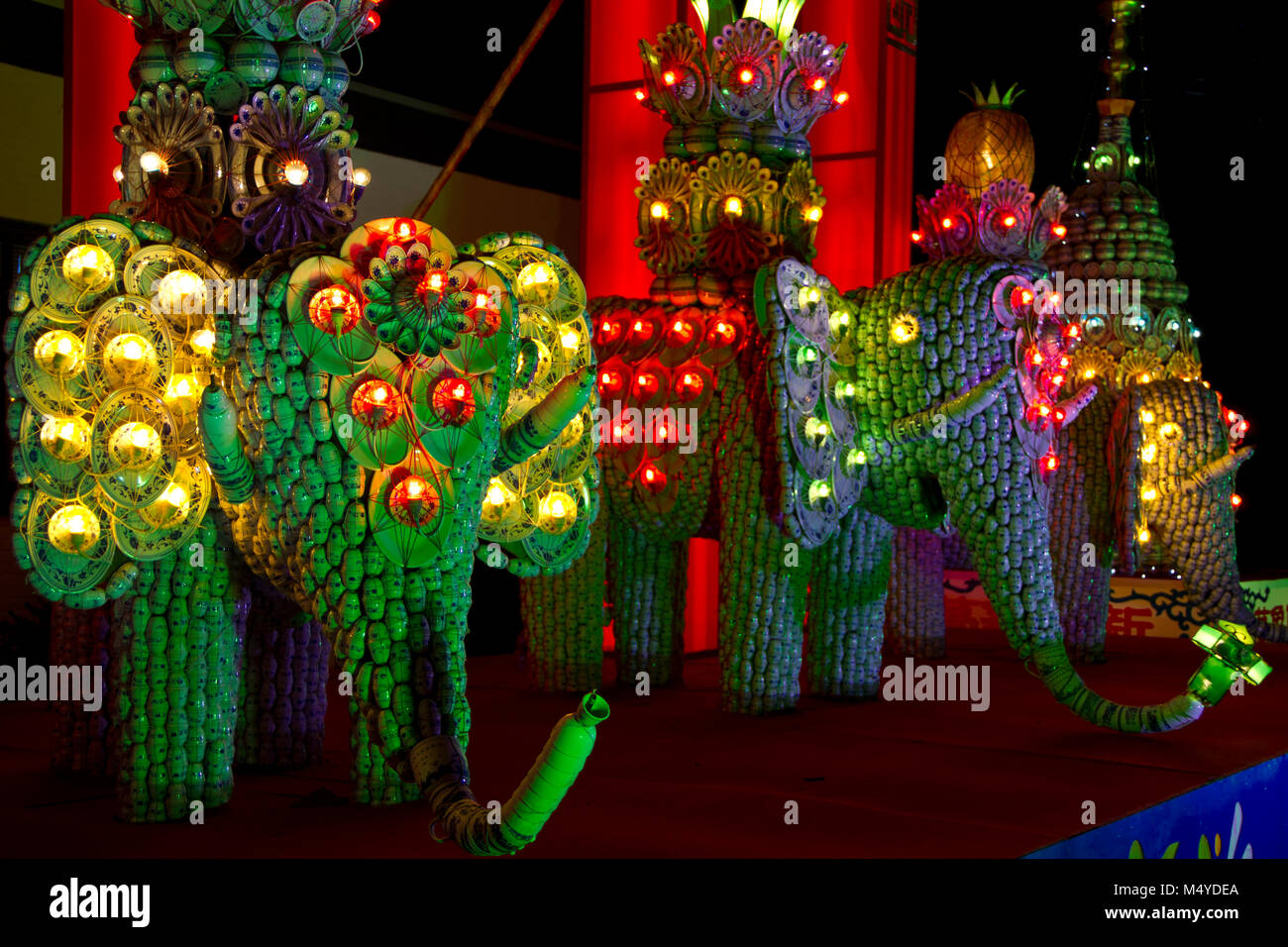 Haren, the Netherlands - November 22, 2011: Three elephants made of Chinese soup cups, decorated with colorful light, exposed at Chinese Lantern Light Stock Photo