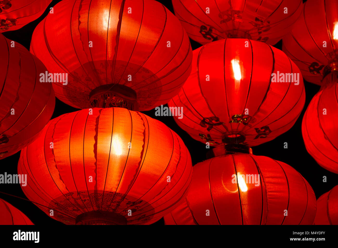 A large group of bright shining red Chinese lanterns at night. Stock Photo
