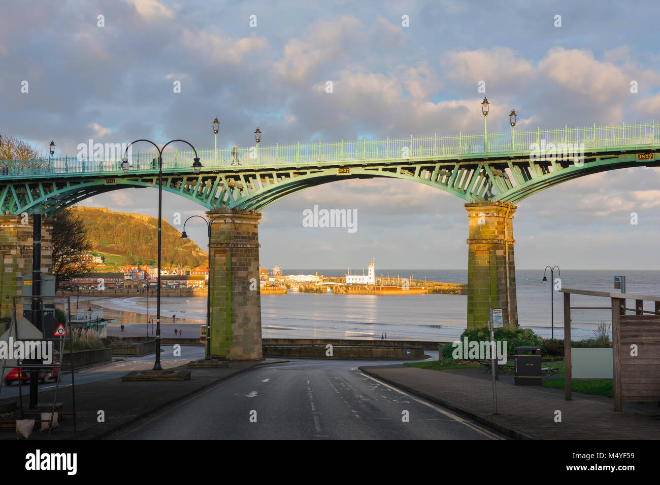 Scarborough UK bridge, sunset view of the harbour in Scarborough framed between the pillars of the Spa Bridge, North Yorkshire, England. Stock Photo