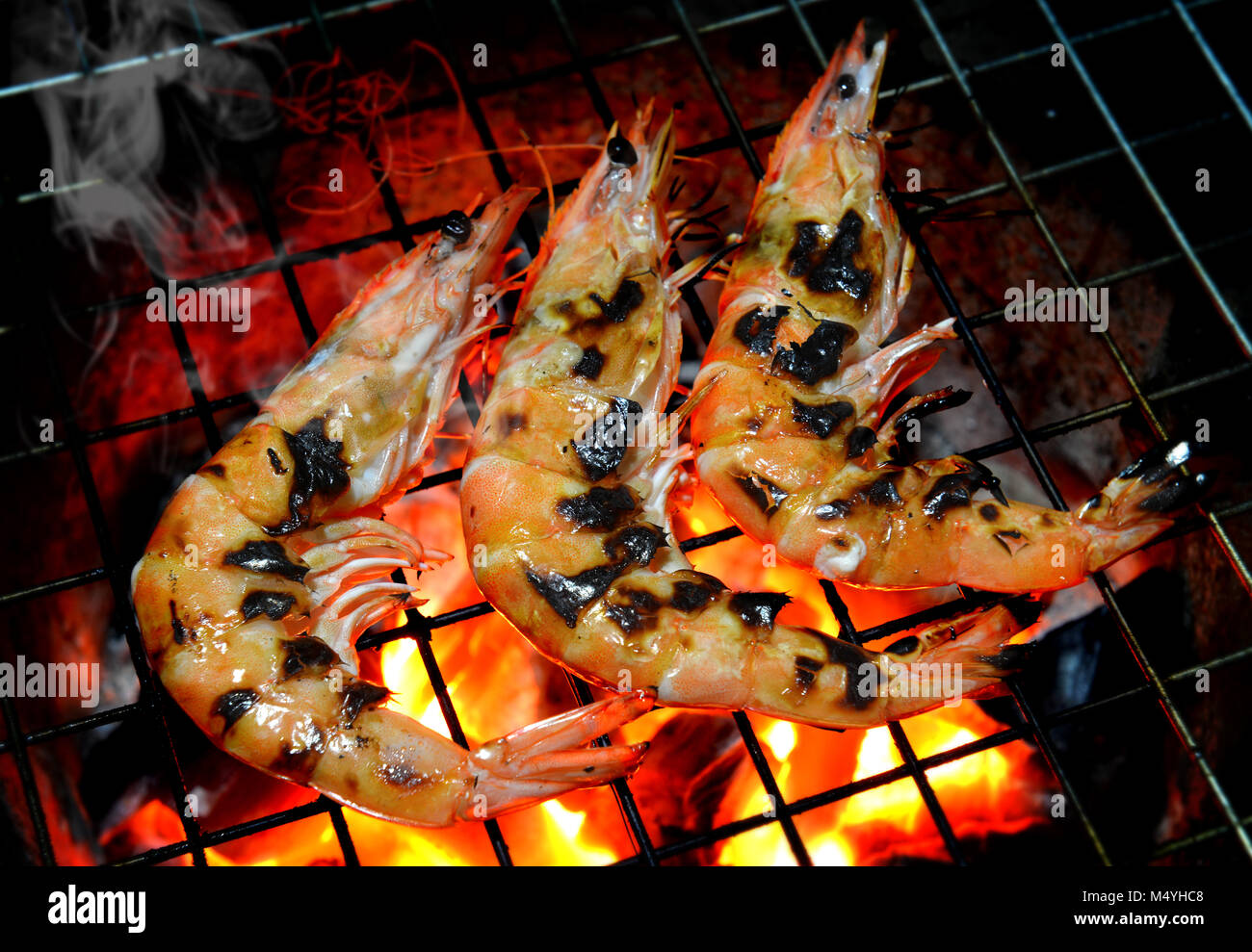 Grill Shrimp in hot fire from charcoal photo in outdoor lowlight