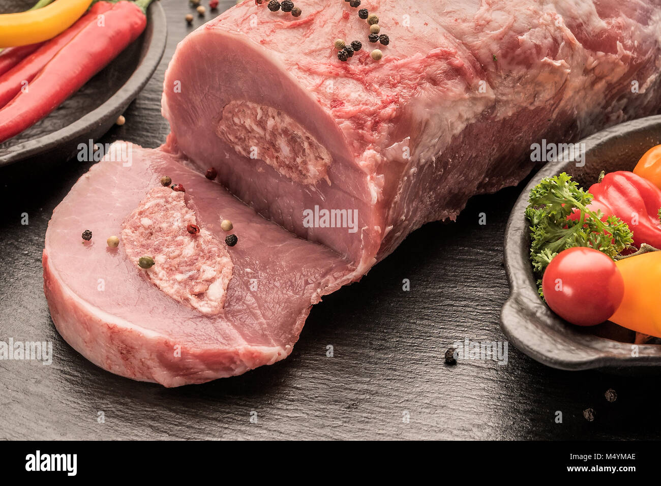 Product photos, Slaughter, Food, Germany, Rhineland-Palatinate, February 17. Freshly slaughtered pork. A meat filled with Mett lies on a plate. Stock Photo