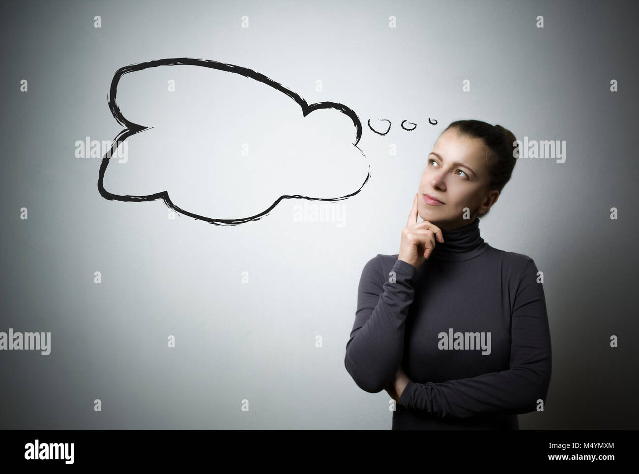Ideas in the head of an attractive woman. A thinking girl ponders a thought. Stock Photo