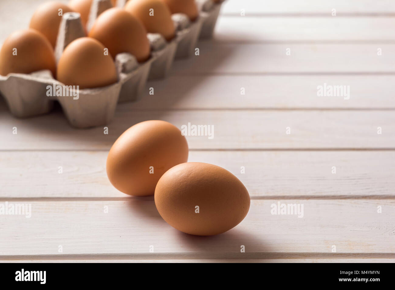 Raw, brown, chicken eggs on wooden white boards. Stock Photo