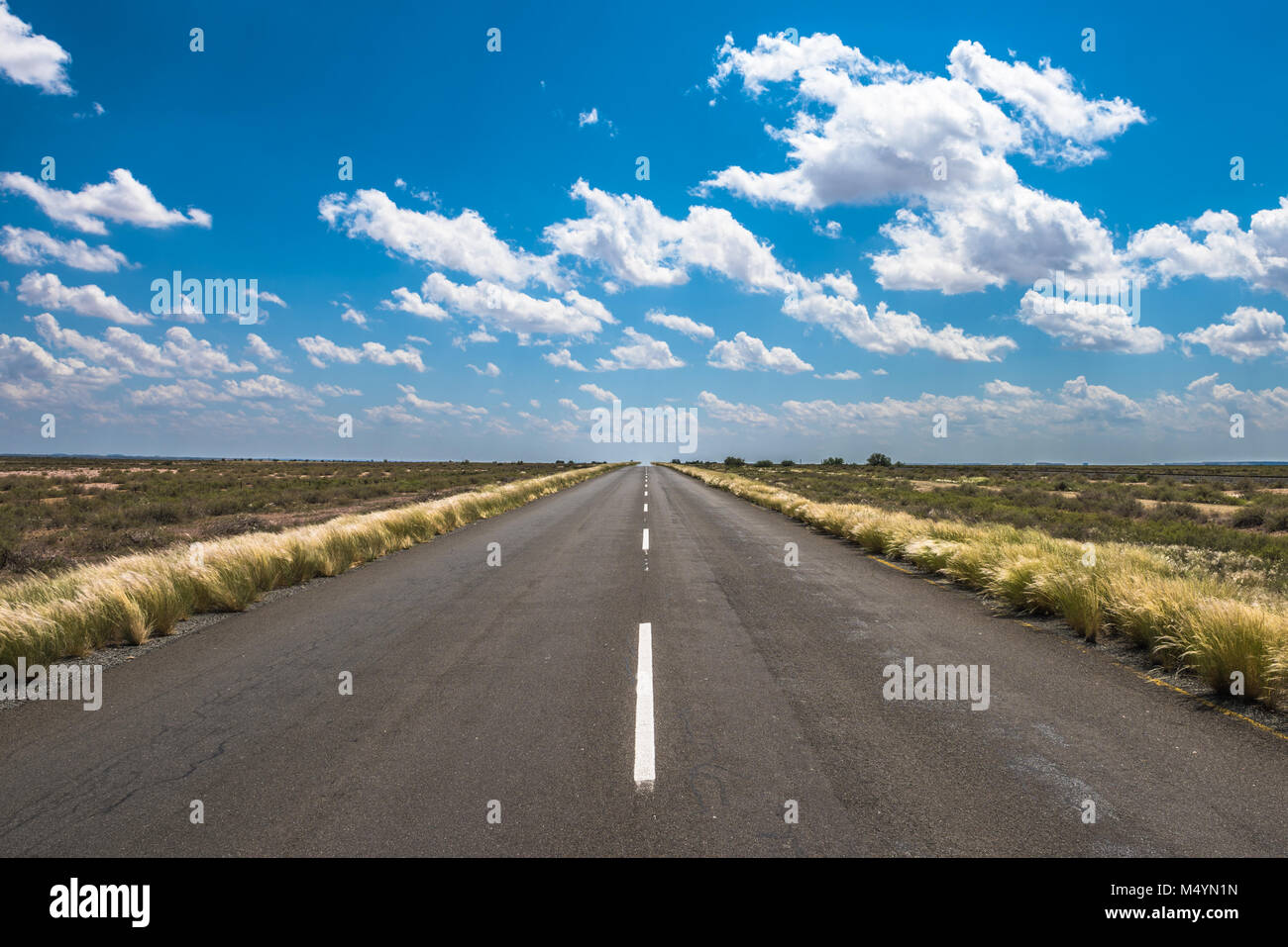 vibrant image of highway and blue cloudy sky Stock Photo - Alamy
