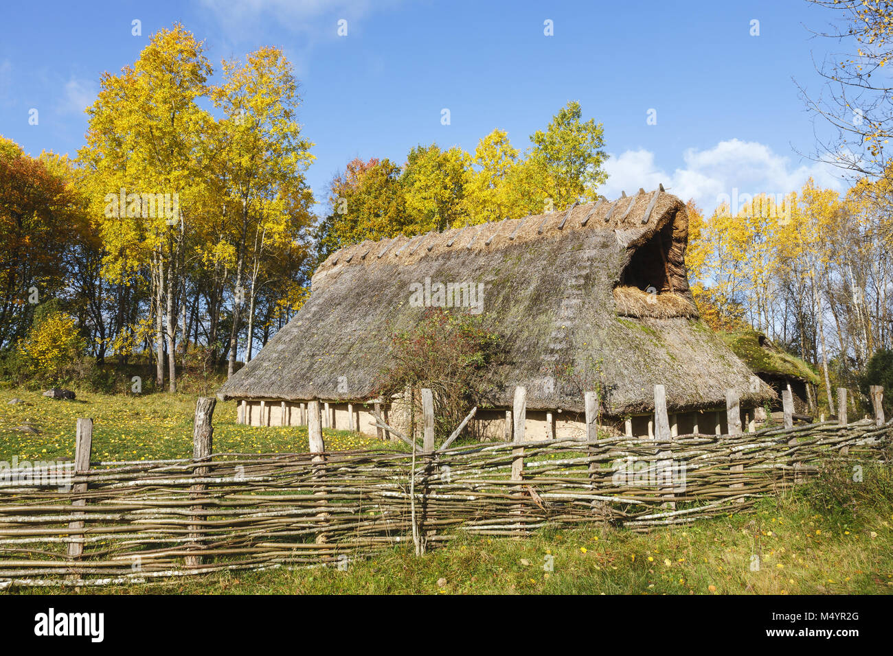 Longhouse on a meadow with autumn colors in the landscape Stock Photo
