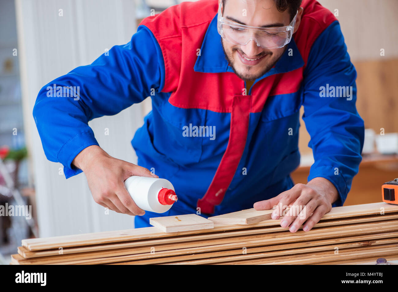 Yooung repairman carpenter working with paint painting Stock Photo Alamy