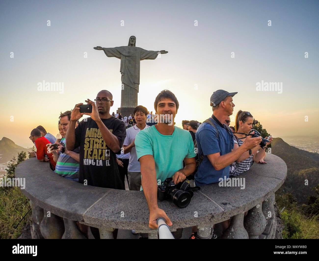 Man taking selfie at Christ the Redeemer statue, Corcovado Mountain, Rio de Janeiro, Brazil Stock Photo