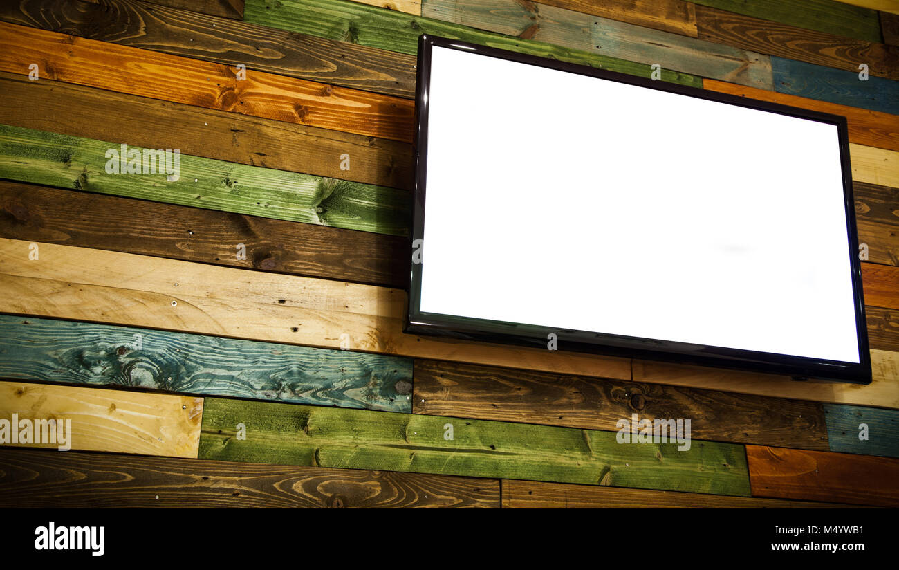 Plasma TV on the wooden wall of the room,Plasma TV hanging on wall. Stock Photo