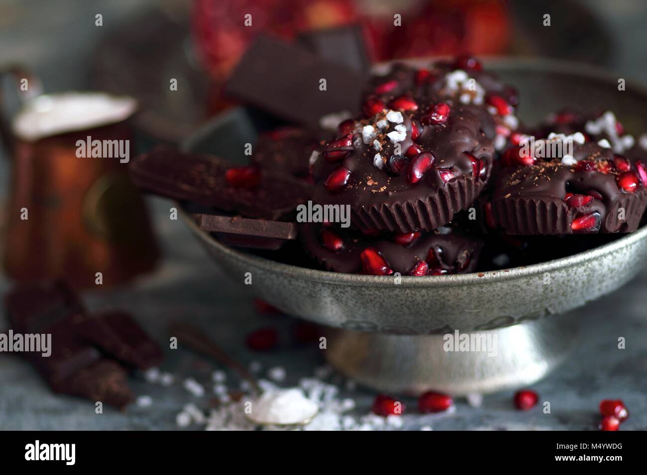 Metal bowl with chocolate bars with pomegranate and sea salt Stock Photo