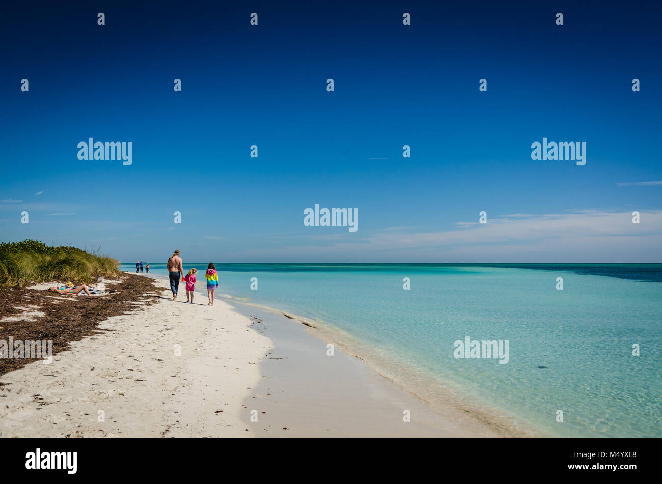 Families walking along Bahia Honda Beach at Bahia Honda State Park in the Florida Keys. Stock Photo