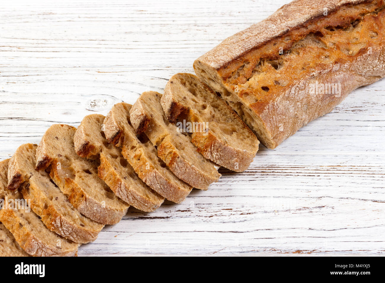French bread, Baguette sliced on chopping board. Stock Photo