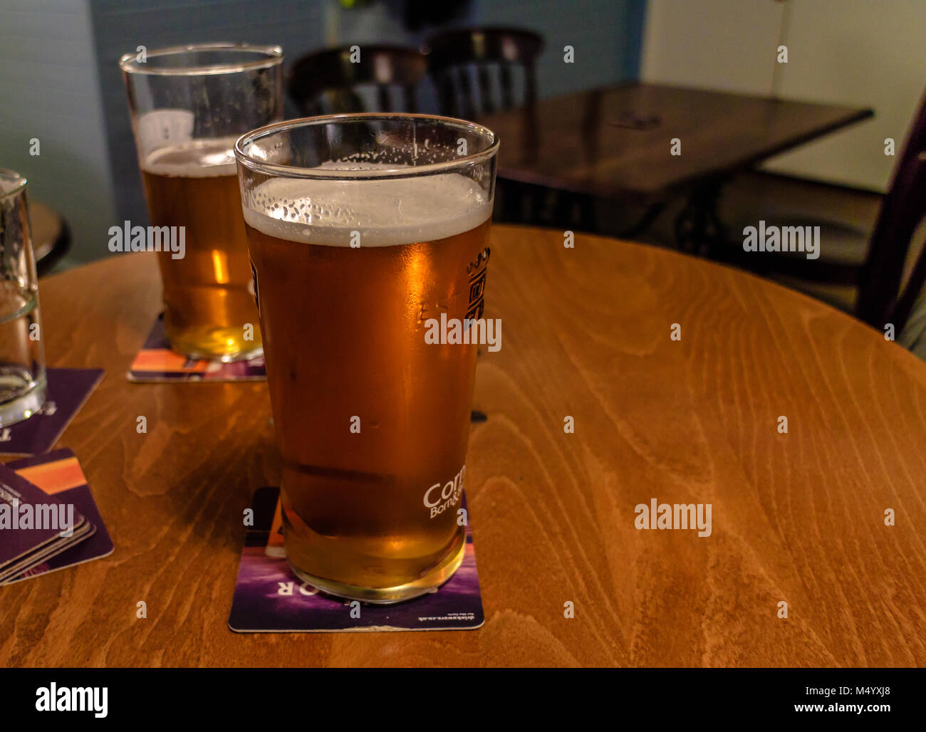 Real ale in a glass on a table top in a pub Stock Photo