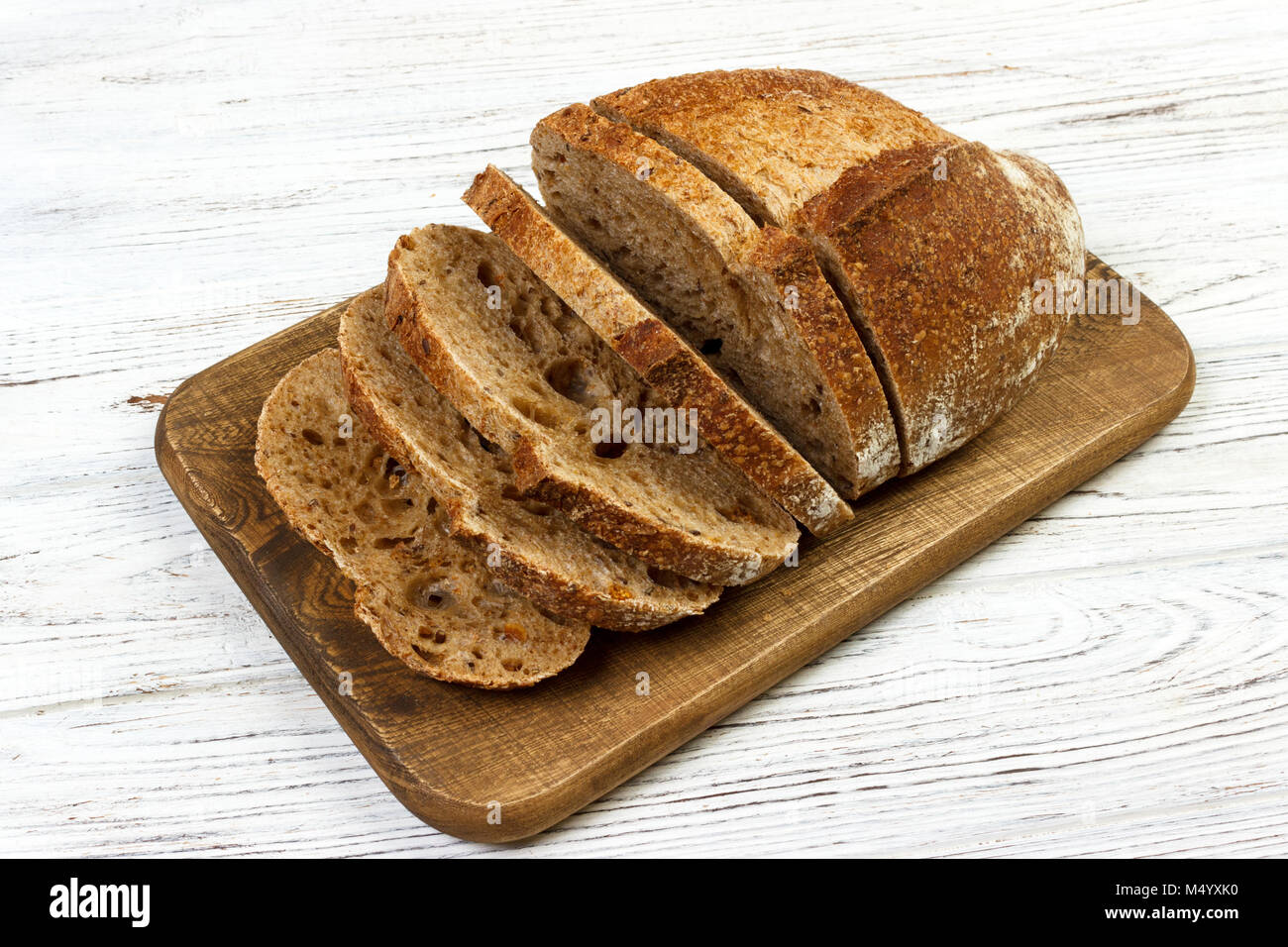 french sliced bread on wooden cutting board. Stock Photo