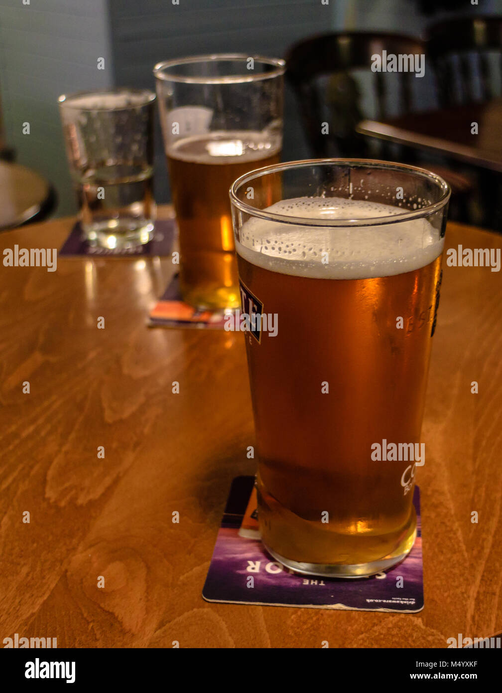 Real ale in a glass on a table top in a pub Stock Photo