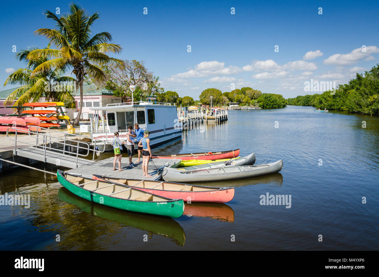 Colorful collection of canoes docked at pier on the bay in Biscayne National Park. Stock Photo
