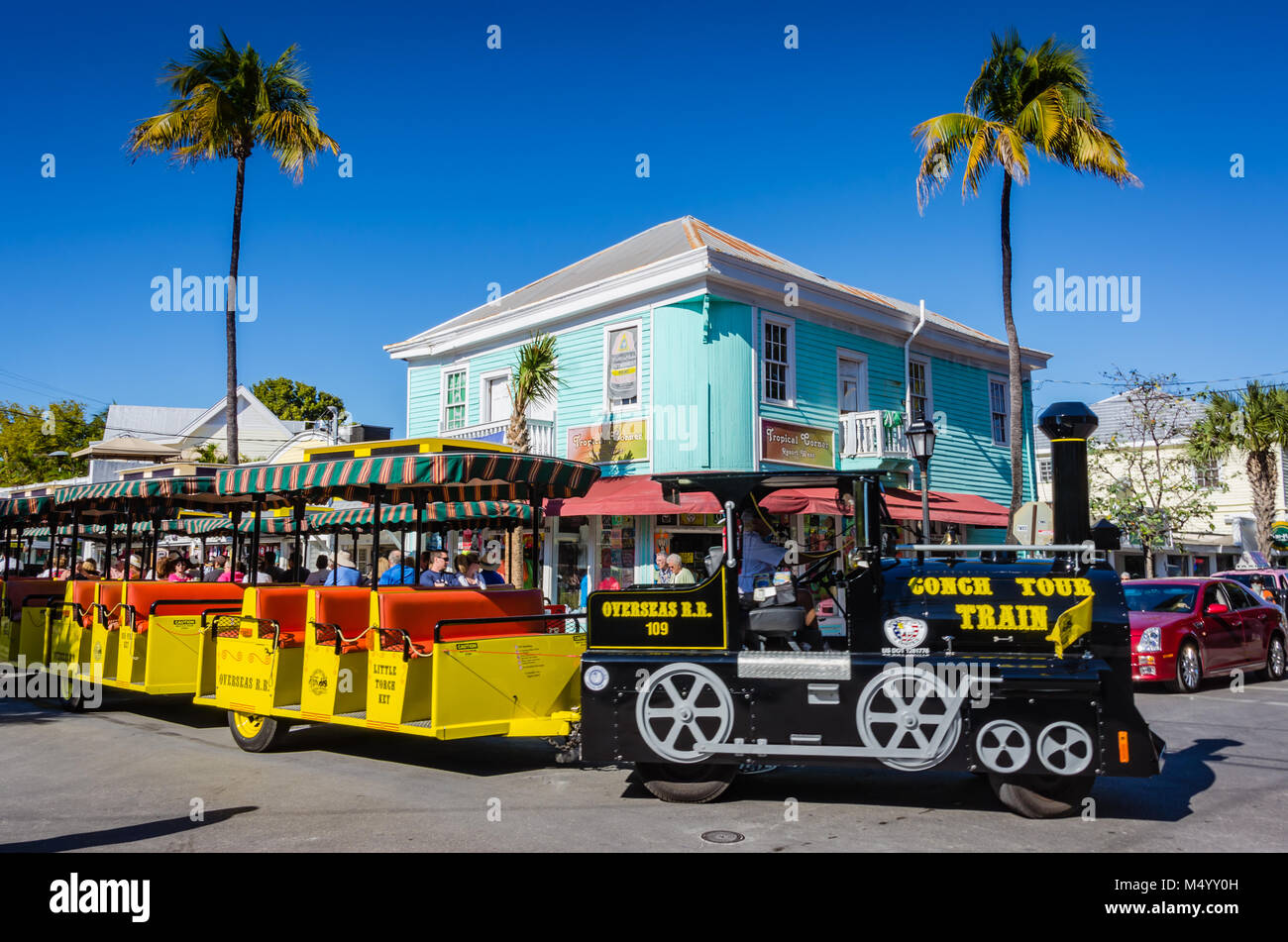 Tours of Key West, FL aboard the colorful Conch Tour Train seen here turning the corner of Green Street. Stock Photo
