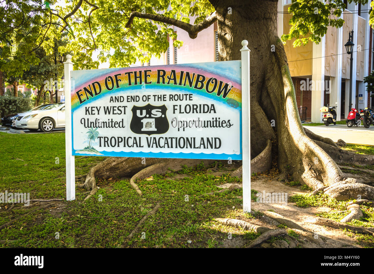 End of the Rainbow sign next to Kapok tree and end of U.S. Route 1. US 1 travels along the east coast of Florida, beginning in Key West running 2,369  Stock Photo