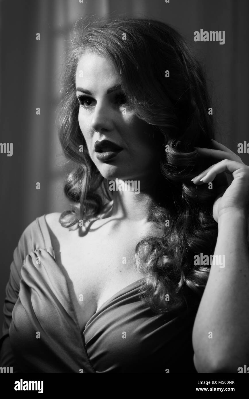 Film Noir woman with dramatic lighting Stock Photo