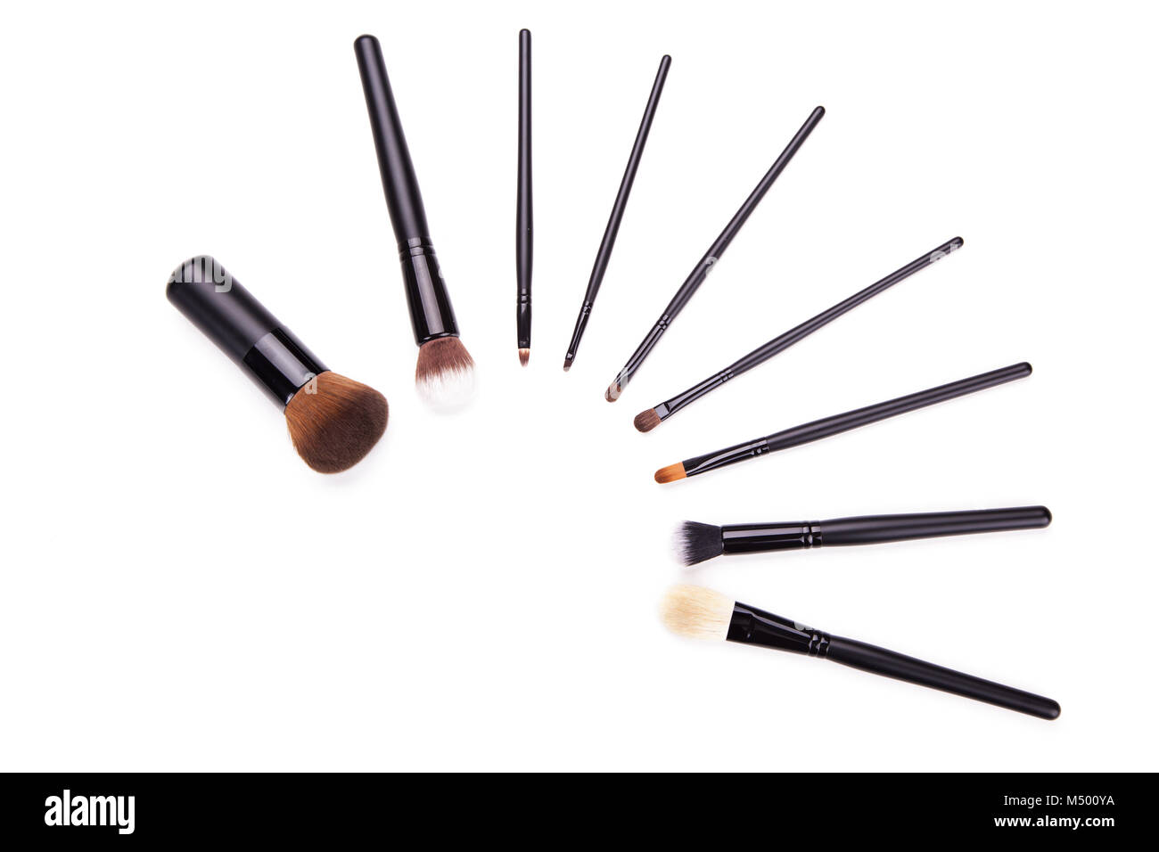 Various makeup brushes isolated over white background,Flat top view set of essential professional make-up brushes on white background. Copy space for  Stock Photo