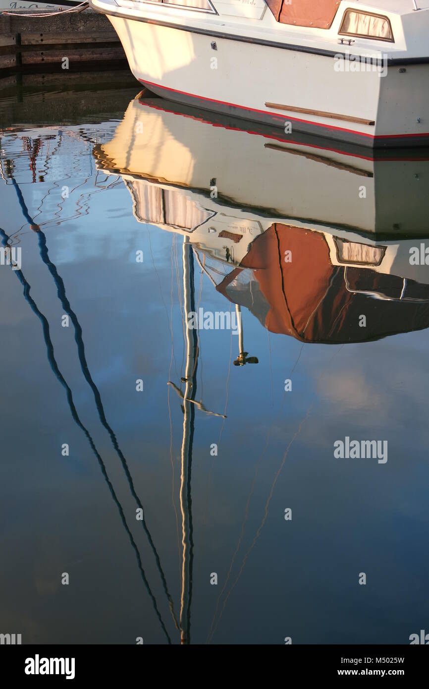 Boat reflected in water Stock Photo - Alamy