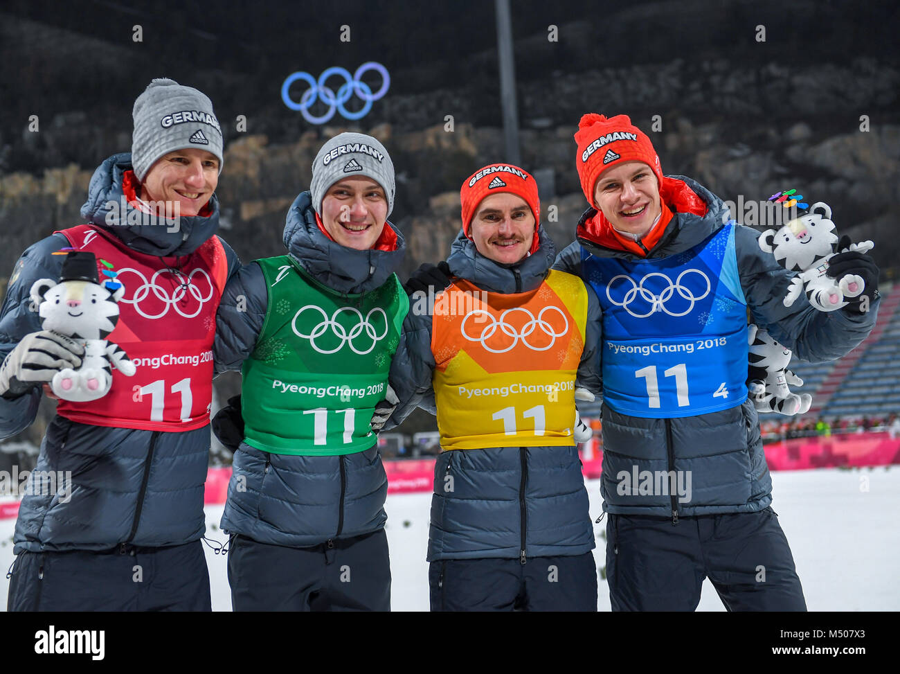 19 February 2018, South Korea, Pyeongchang, Olympics, ski jumping, team  jumping, large hill, mens, Alpensia Sliding Centre: Karl Geiger (L-R),  Stephan Leyhe, Richard Freitag and Andreas Wellinger of Germany  celebrating. They jointly
