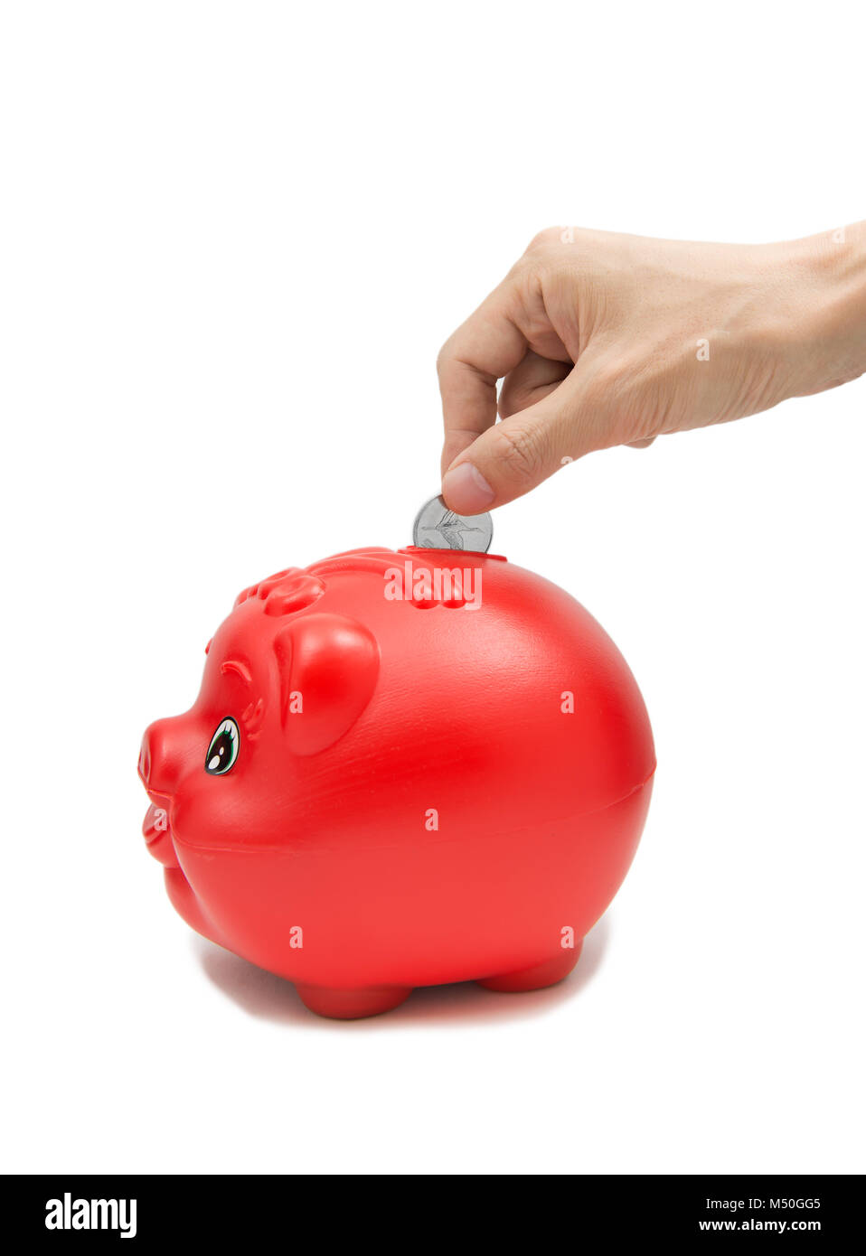 Hand inserting coin into piggybank isolated on white background Stock Photo