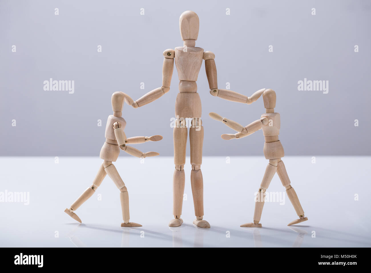 Wooden Dummy Caring For Child Dummy Against White Background Stock