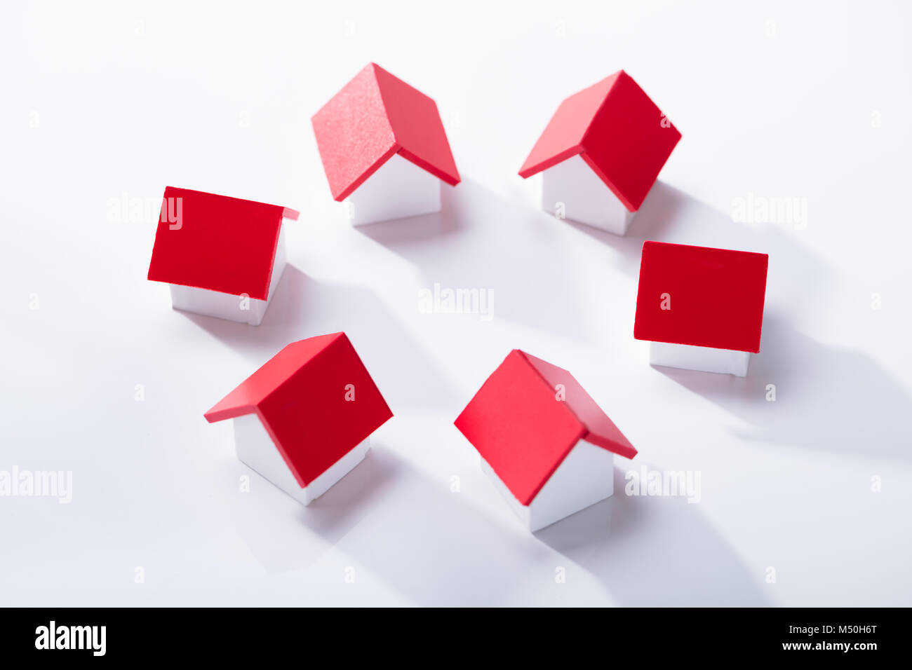 Overhead View Of House Models Arranged In Circle Over The White Background Stock Photo