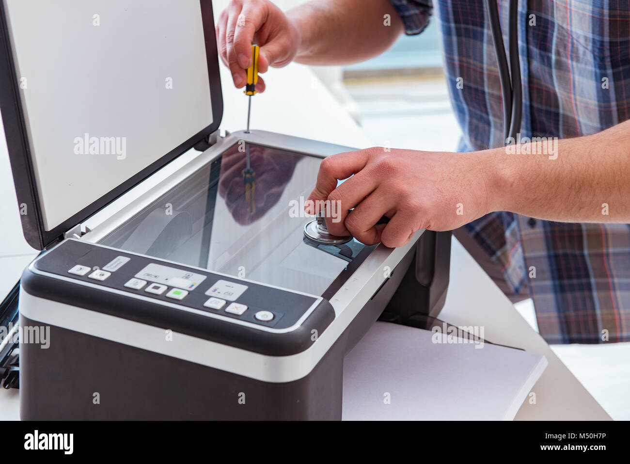 Repairman repairing broken color printer Stock Photo Alamy