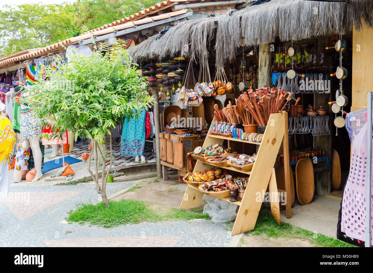 handmade wooden pieces being sold at craft fair in Bahia in Brazil. Spoons, bundles, purses, musical instruments. Stock Photo
