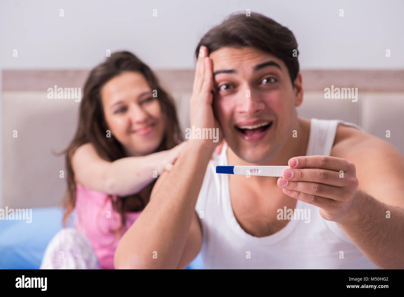 Young family with pregnancy test results Stock Photo Alamy