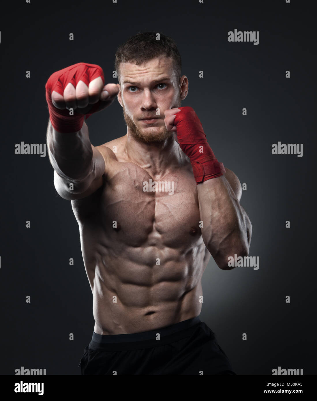 Muscular kickbox or muay thai fighter punching Stock Photo Alamy